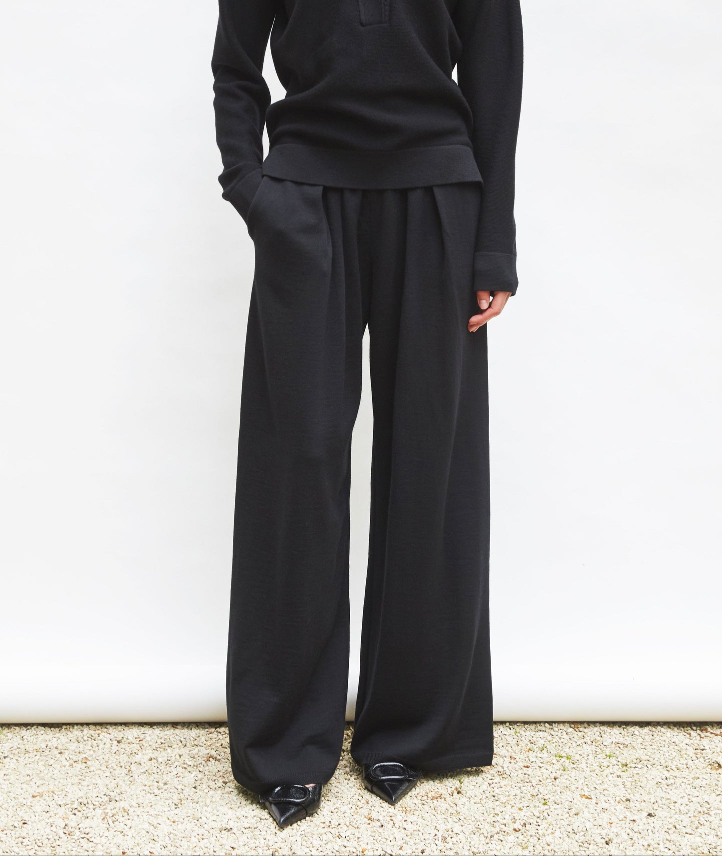 Black wide-leg knit pants with front pleats