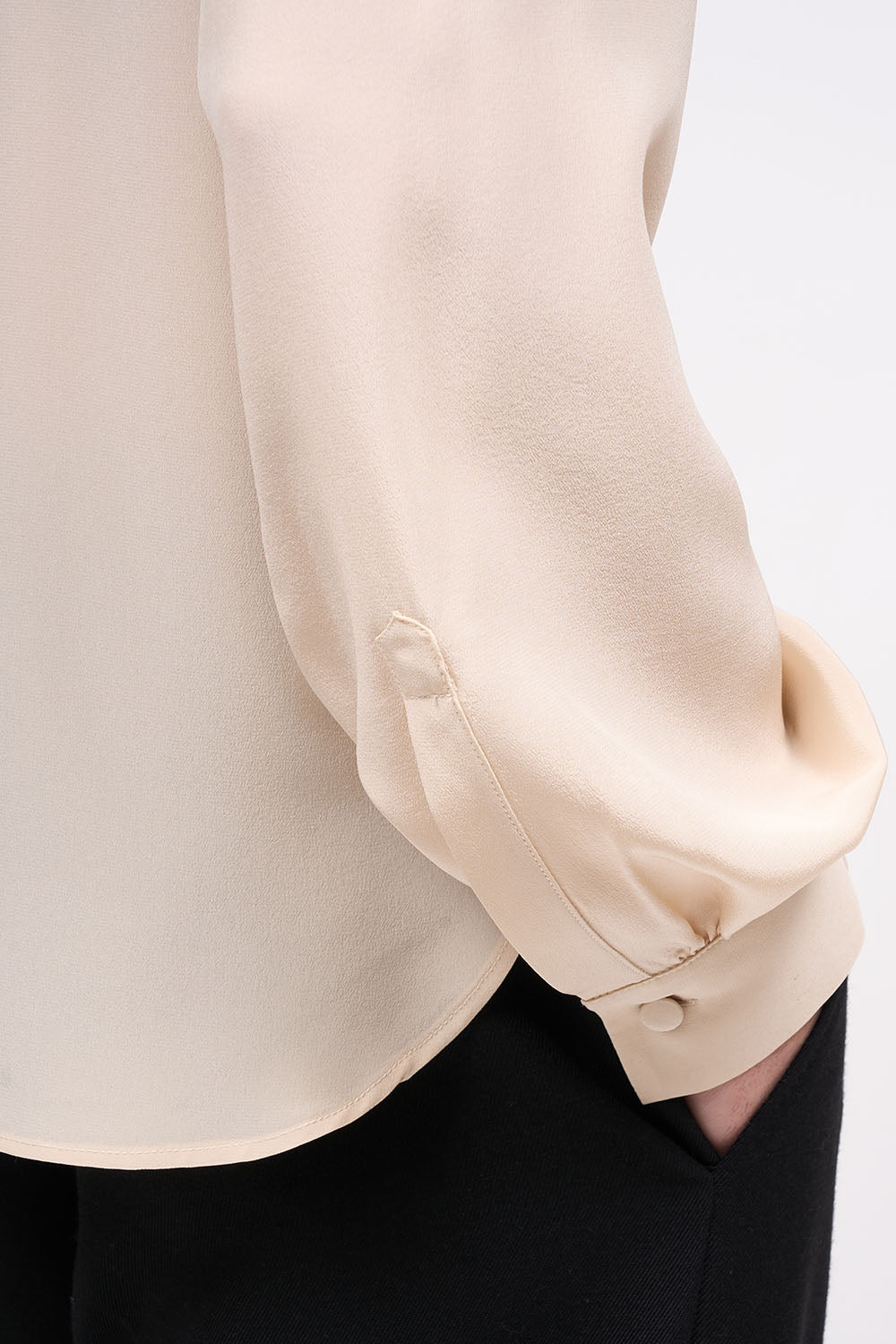 Close-up of the sleeve and covered buttons on the Paul & Joe Lucas nude silk blouse