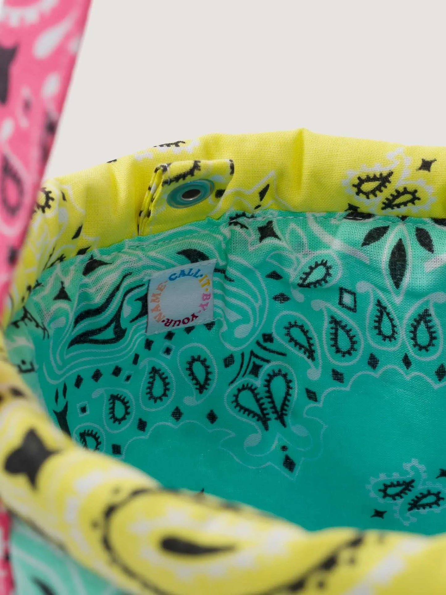 Pale blue Colorblock bandana bucket bag, adjustable strap, by brand Call it by your name, tag close-up