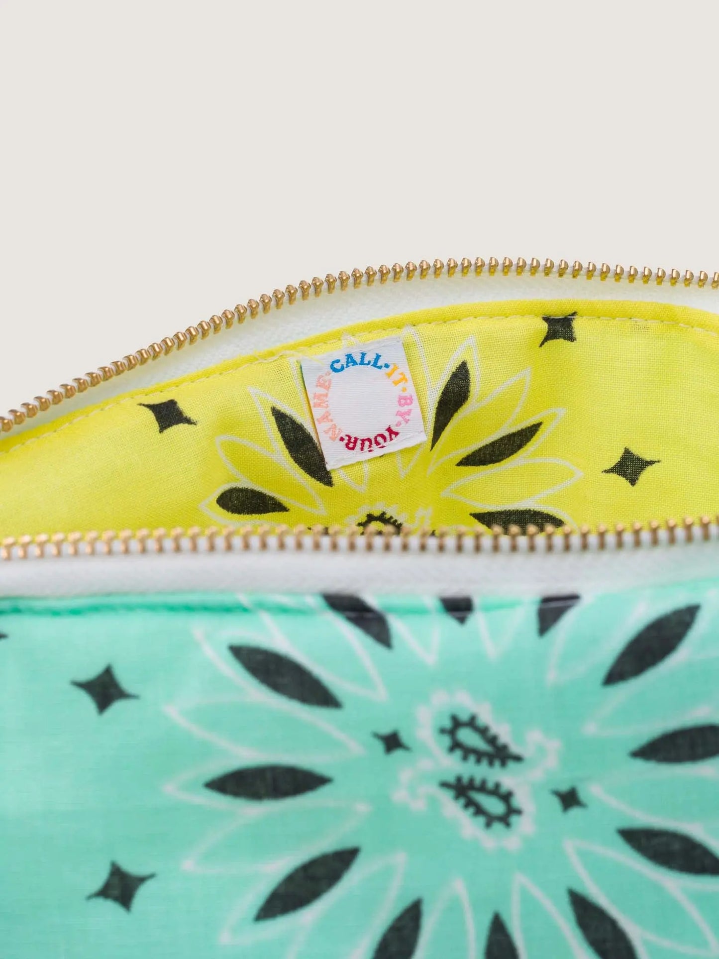 mint teal and yellow bandana toiletry case for makeup by call it by your name with a rainbow embroidery, interior detail