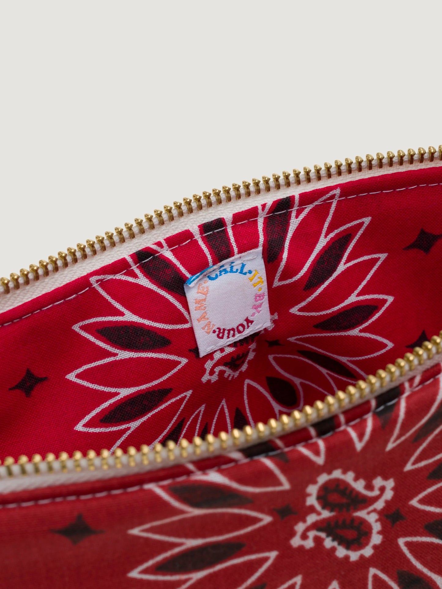 Red bandana large cosmetic pouch for makeup closeup on tag
