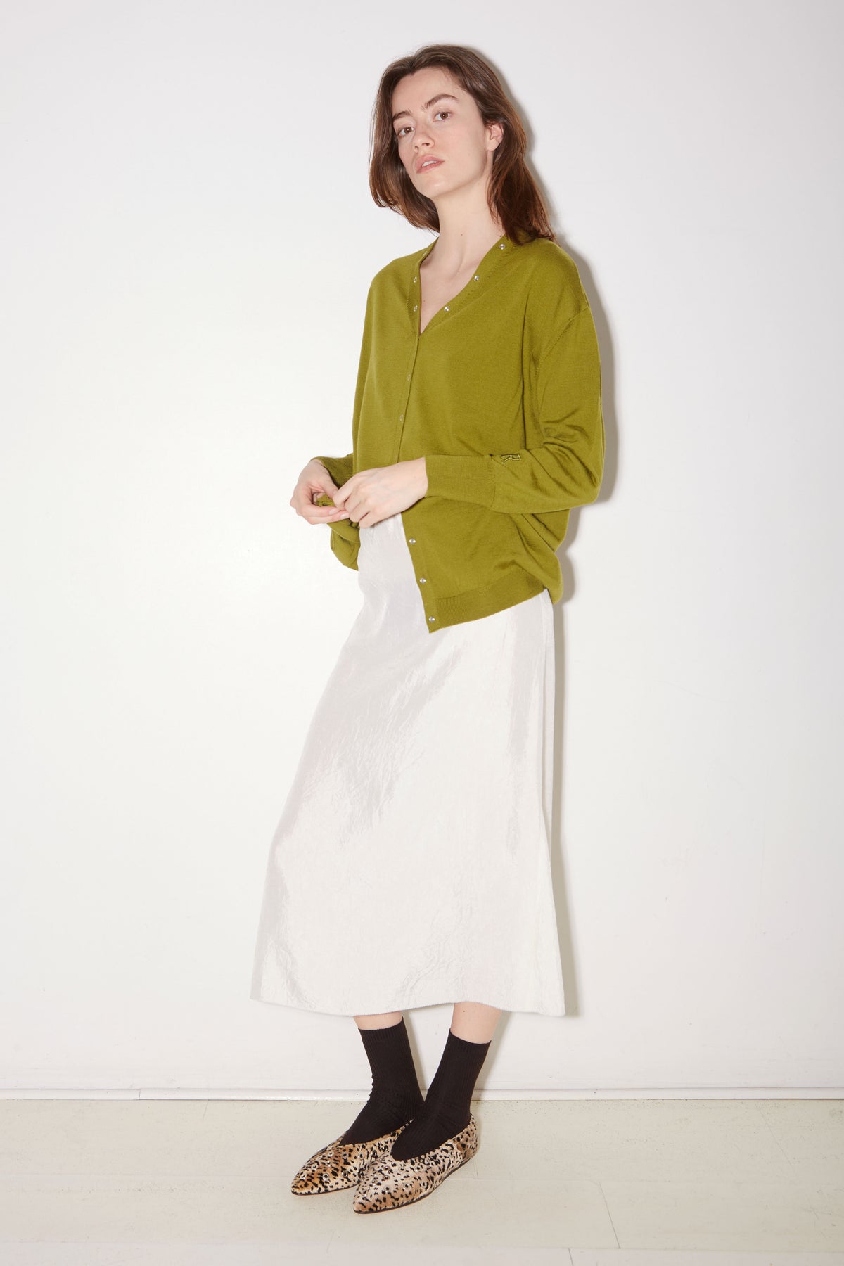 Roseanna Lucia moss cardigan styled with a white skirt, full-length view