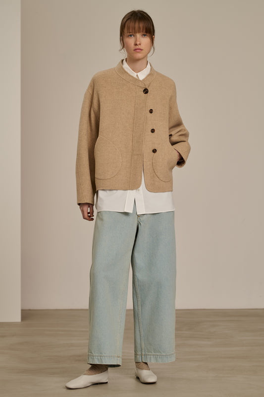 Model wearing the beige Soeur Windsor coat with light jeans, front view