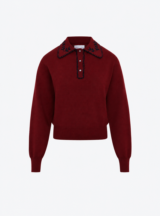 Flat-lay view of the Molli Amour amaranth knit polo shirt with midnight blanket-stitch embroidery on the collar and placket