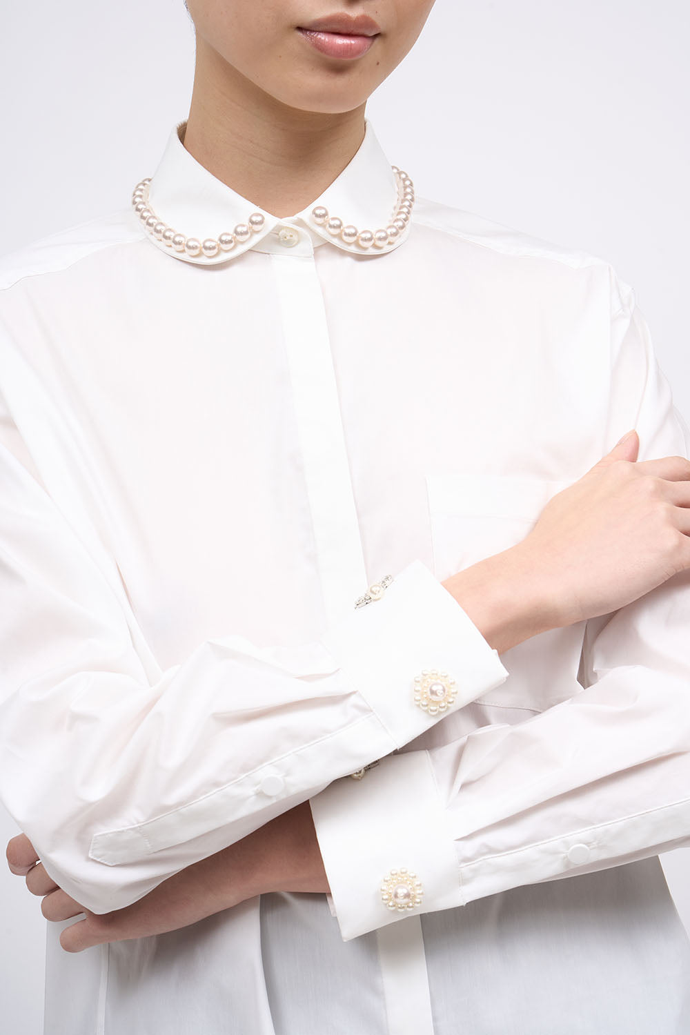 Close-up of the pearl-embellished rounded collar on the Paul & Joe Carla white poplin shirt