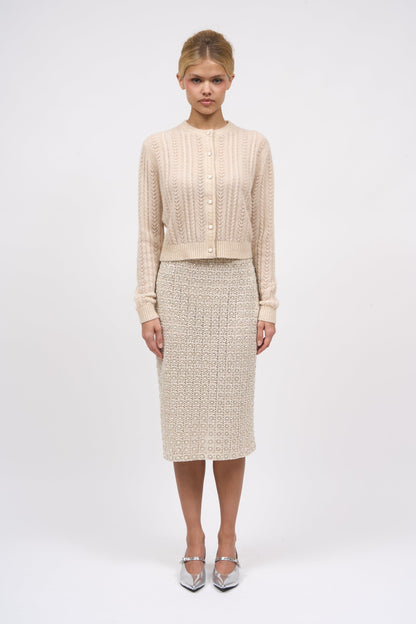 Paul & Joe Diamant guipure lace pencil skirt styled with a cream knit cardigan and silver heels, full-length front view