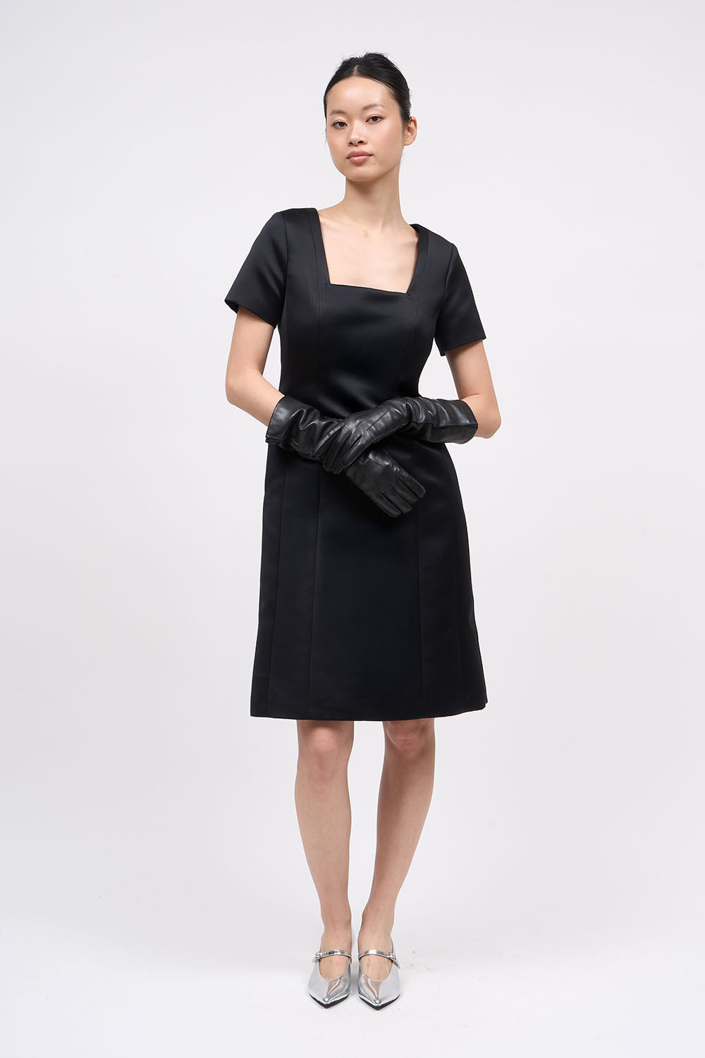Front view of the Paul & Joe Venus black duchess satin dress with square neckline