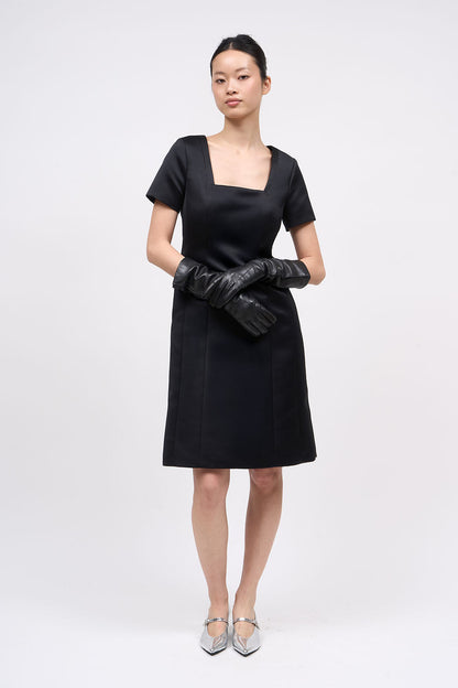 Front view of the Paul & Joe Venus black duchess satin dress with square neckline