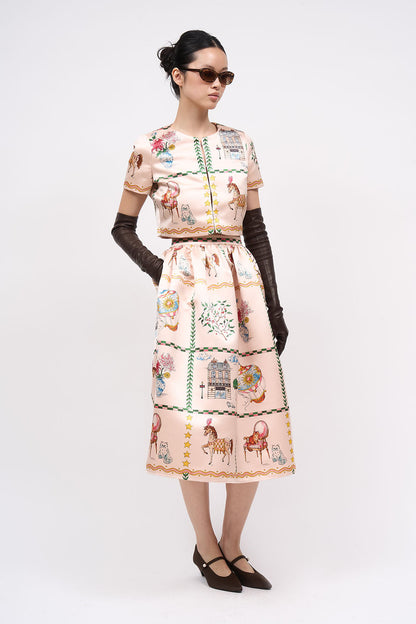 Front view of the Paul & Joe Voyage light pink printed duchess satin short jacket, worn with the matching skirt