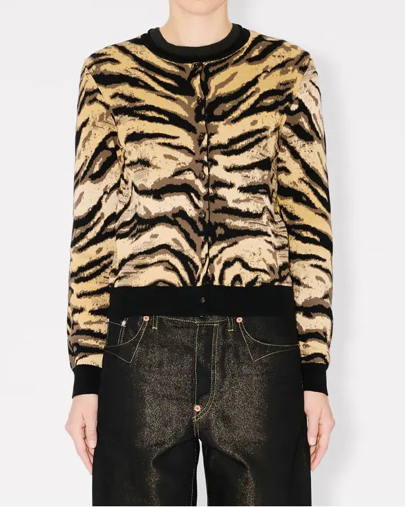 Person wearing a tiger stripe cardigan on a white background