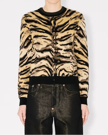 Person wearing a tiger stripe cardigan on a white background