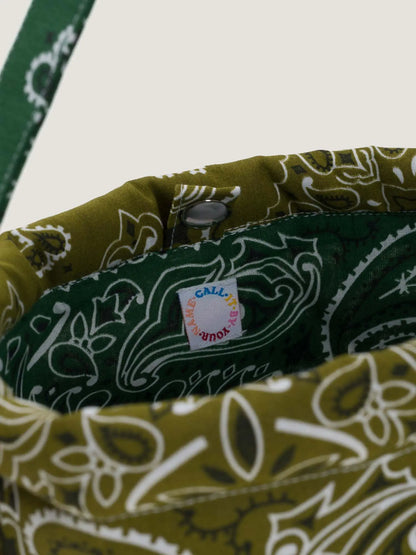 Green bandana bucket bag with adjustable strap by brand Call it by your name, close-up on tag