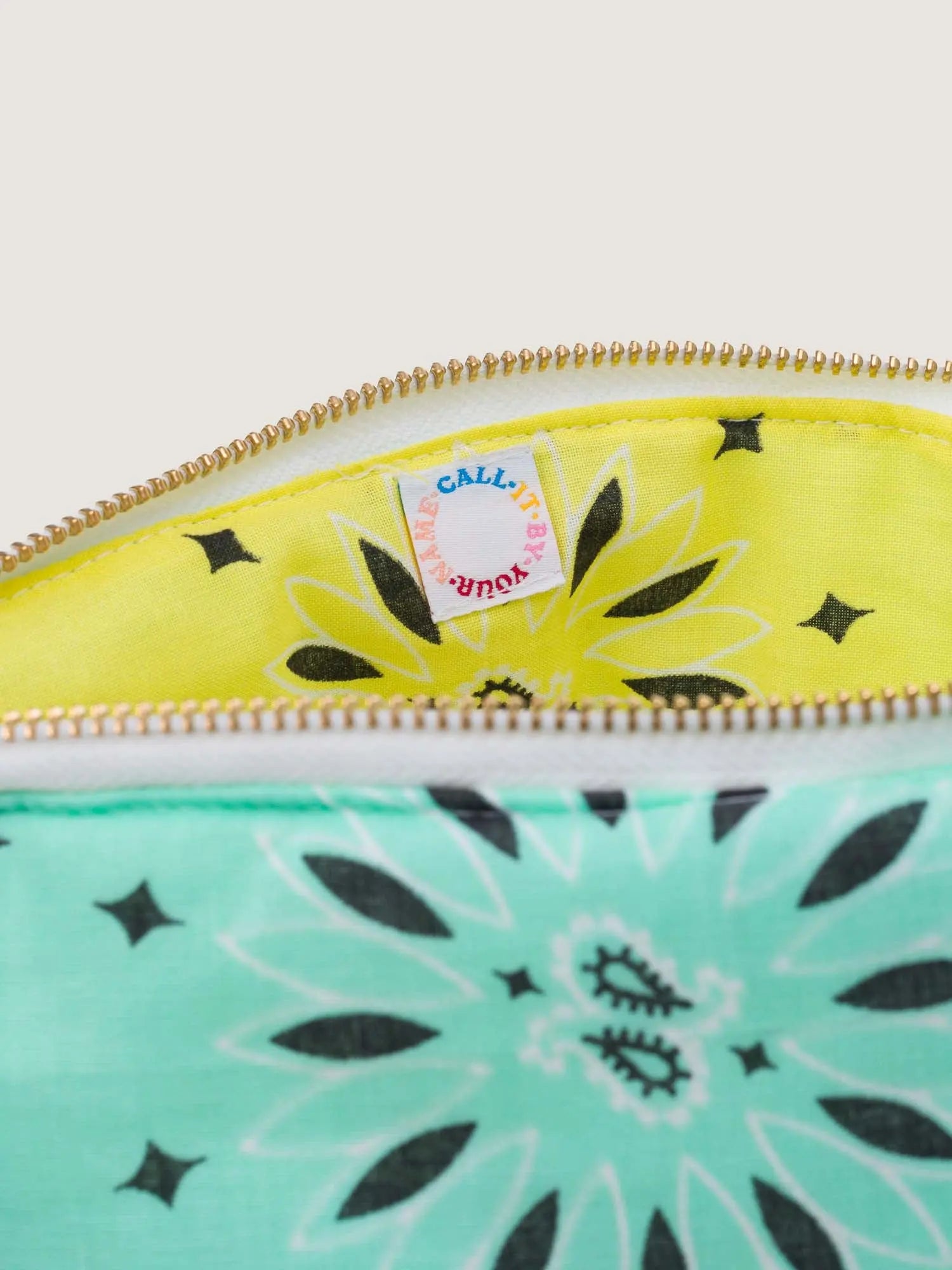 mint teal and yellow bandana toiletry case for makeup by call it by your name with a rainbow embroidery, interior detail