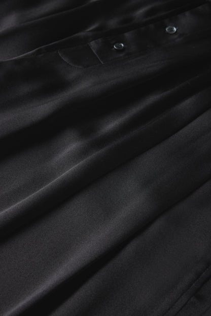 Close-up of the black silk satin and waistband buttons on the Soeur Leopold trousers