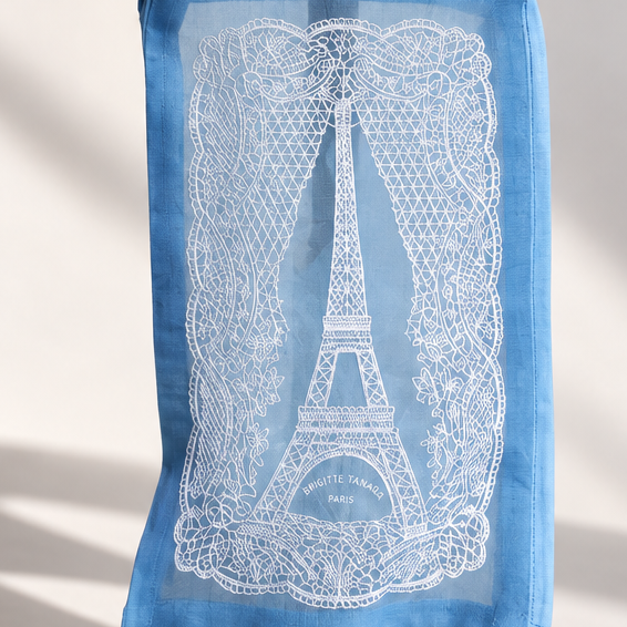 Close-up of the white lace Eiffel Tower embroidery on the Brigitte Tanaka blue pouch