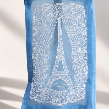 Close-up of the white lace Eiffel Tower embroidery on the Brigitte Tanaka blue pouch