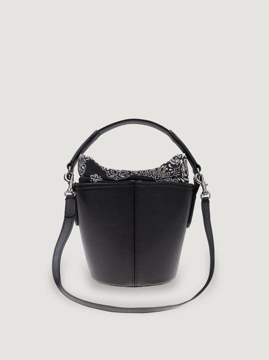 Front view of the Call It By Your Name mini Peekaboo leather bucket bag in black with its shoulder strap