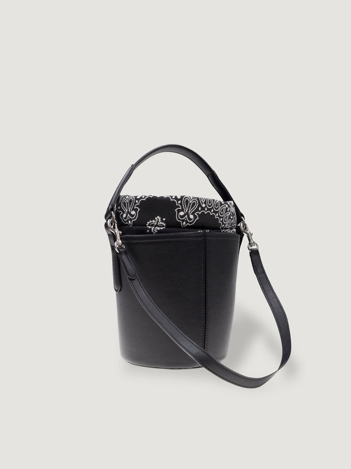 Side view of the Call It By Your Name mini black Peekaboo bag with detachable shoulder strap