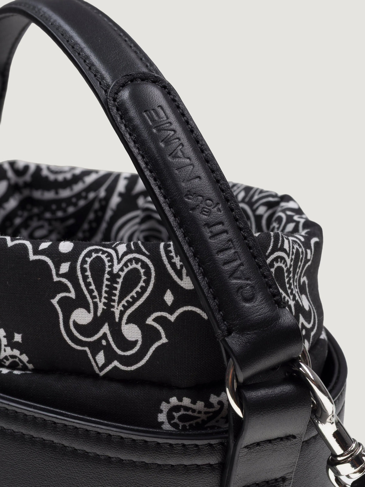 Close-up of the top handle and bandana trim on the Call It By Your Name mini black Peekaboo bag