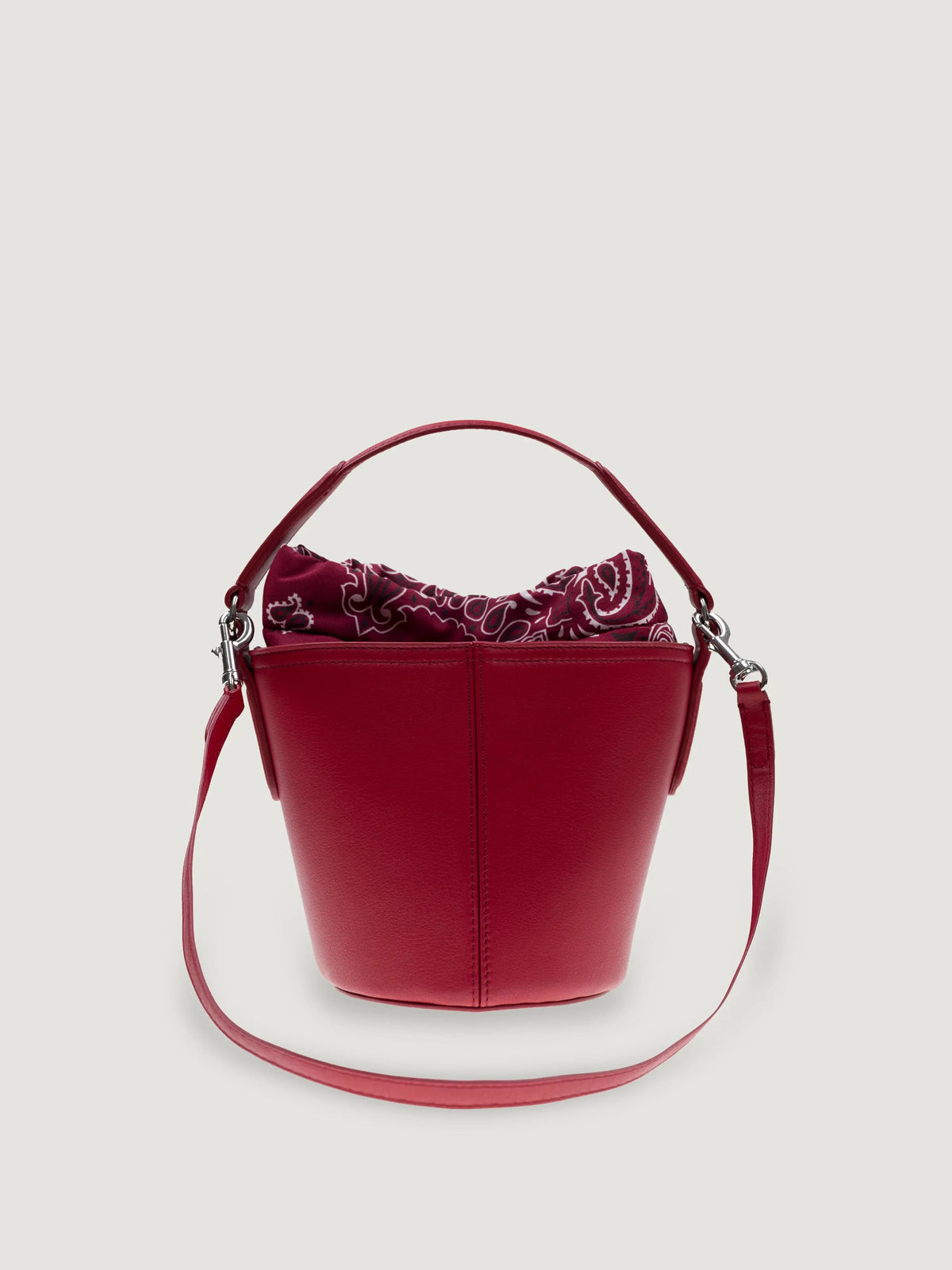 Front view of the Call It By Your Name mini Peekaboo leather bucket bag in cherry with its shoulder strap
