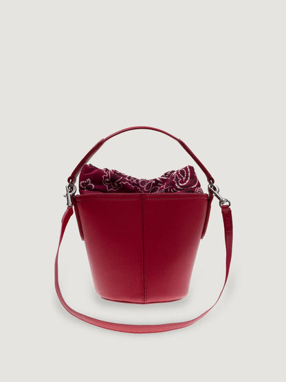 Front view of the Call It By Your Name mini Peekaboo leather bucket bag in cherry with its shoulder strap
