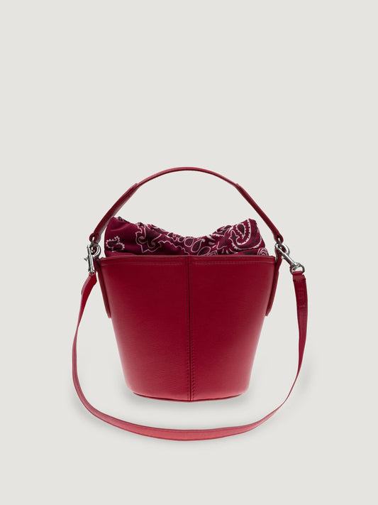 Front view of the Call It By Your Name mini Peekaboo leather bucket bag in cherry with its shoulder strap