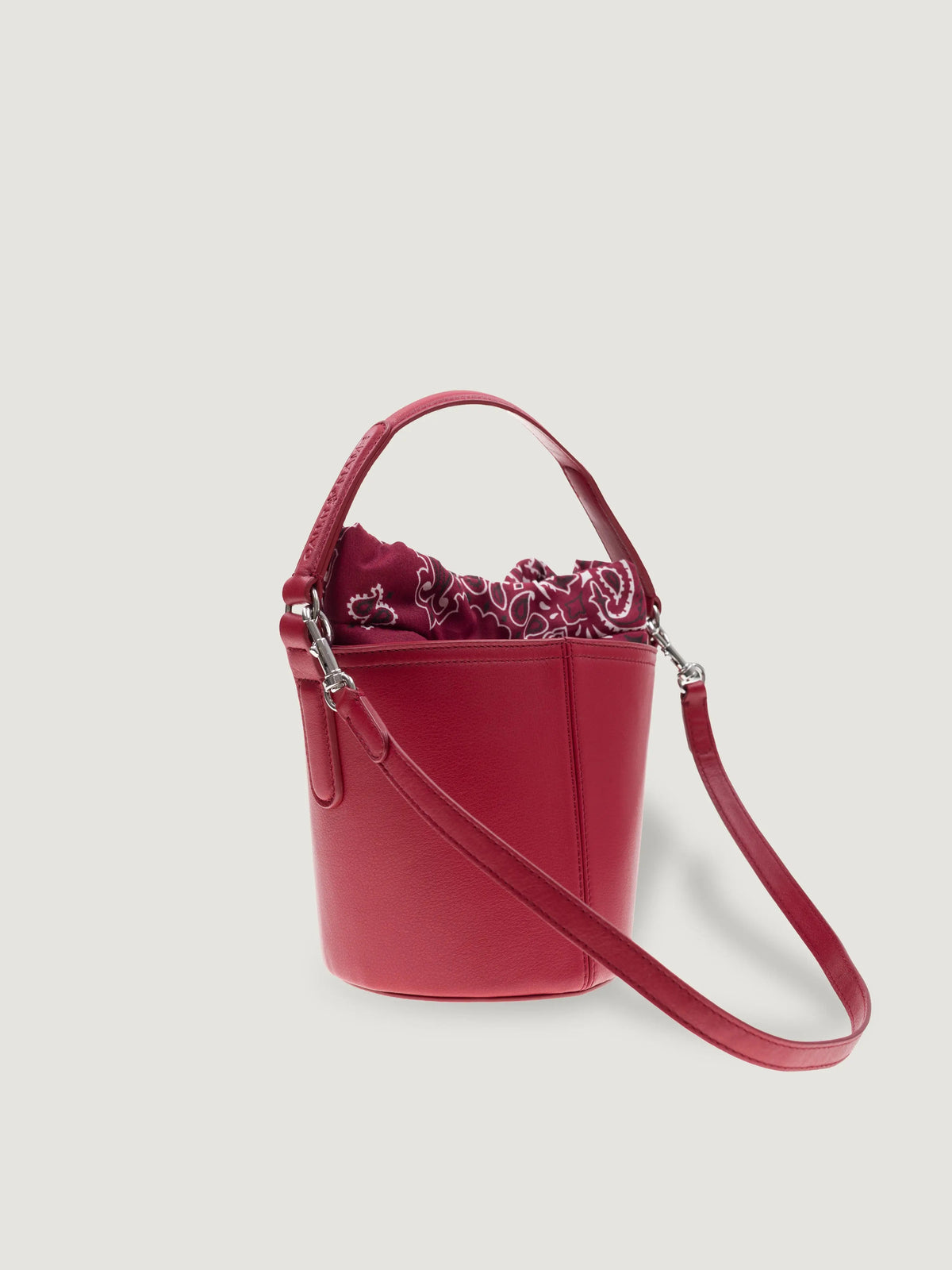 Side view of the Call It By Your Name mini cherry Peekaboo bag with detachable shoulder strap