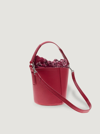 Side view of the Call It By Your Name mini cherry Peekaboo bag with detachable shoulder strap