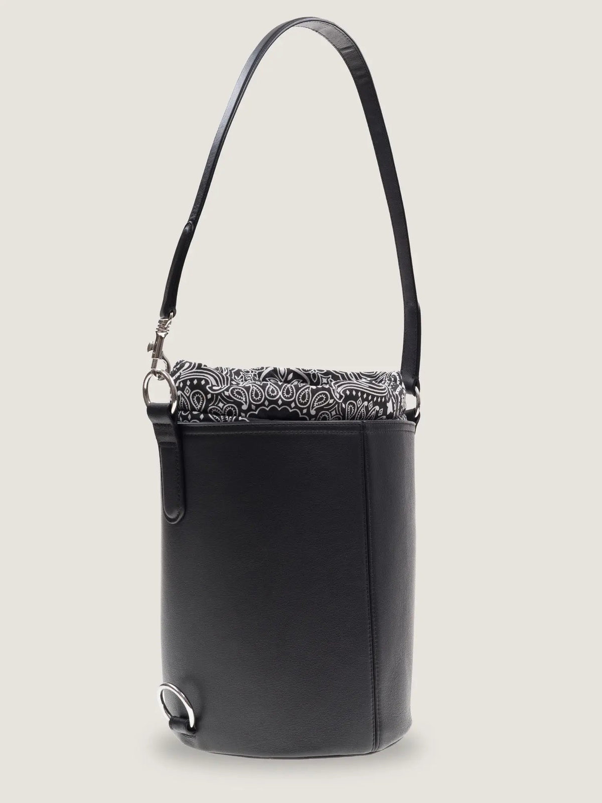 Call It By Your Name black Peekaboo bucket bag with the handle extended and bandana lining showing