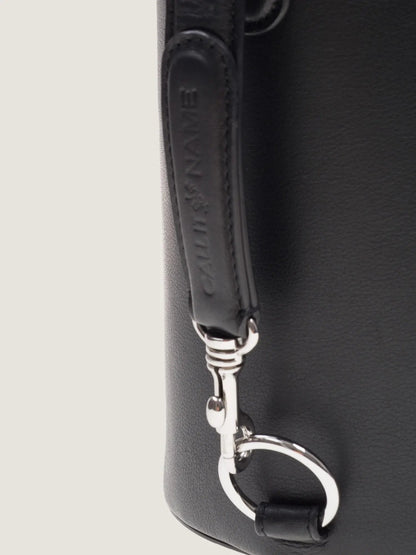 Close-up of the black leather strap and silver snap hook on the Call It By Your Name Peekaboo bag