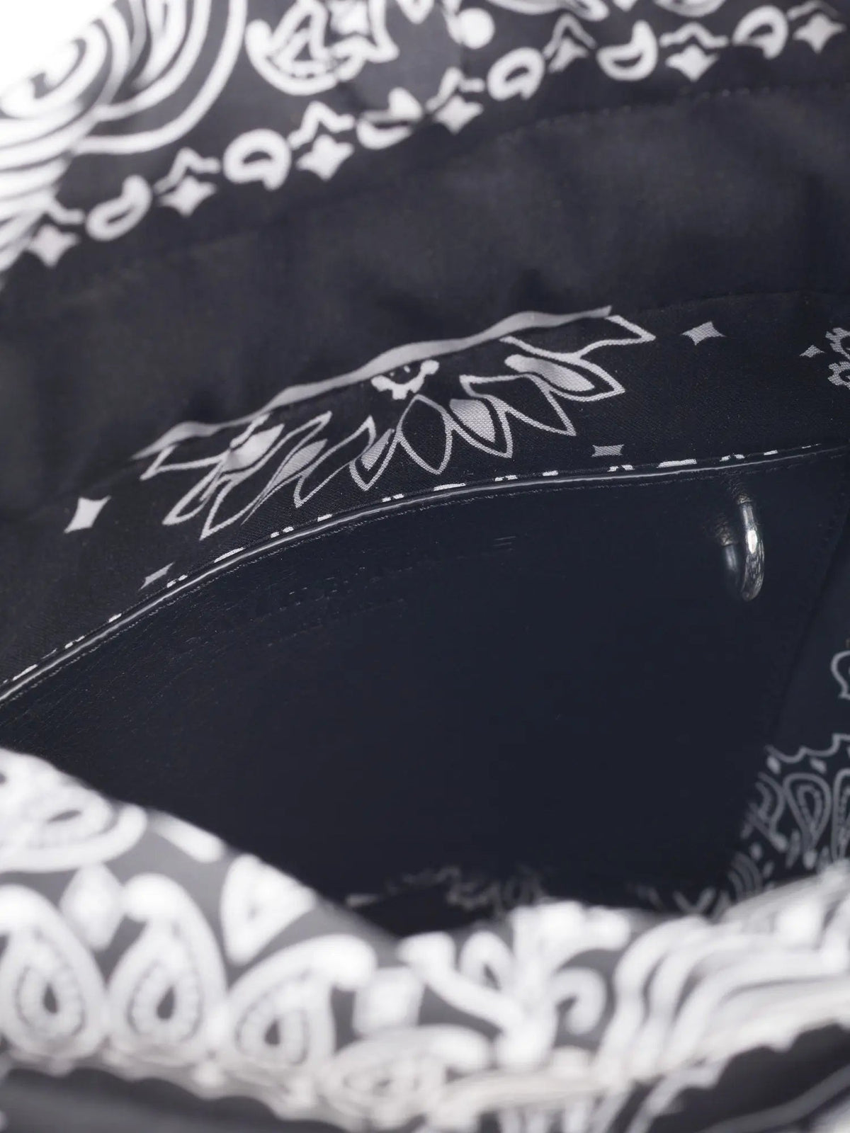Inside of the Call It By Your Name black Peekaboo bag showing the black bandana-print lining