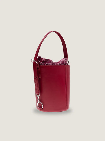 Side view of the Call It By Your Name medium Peekaboo bucket bag in cherry leather