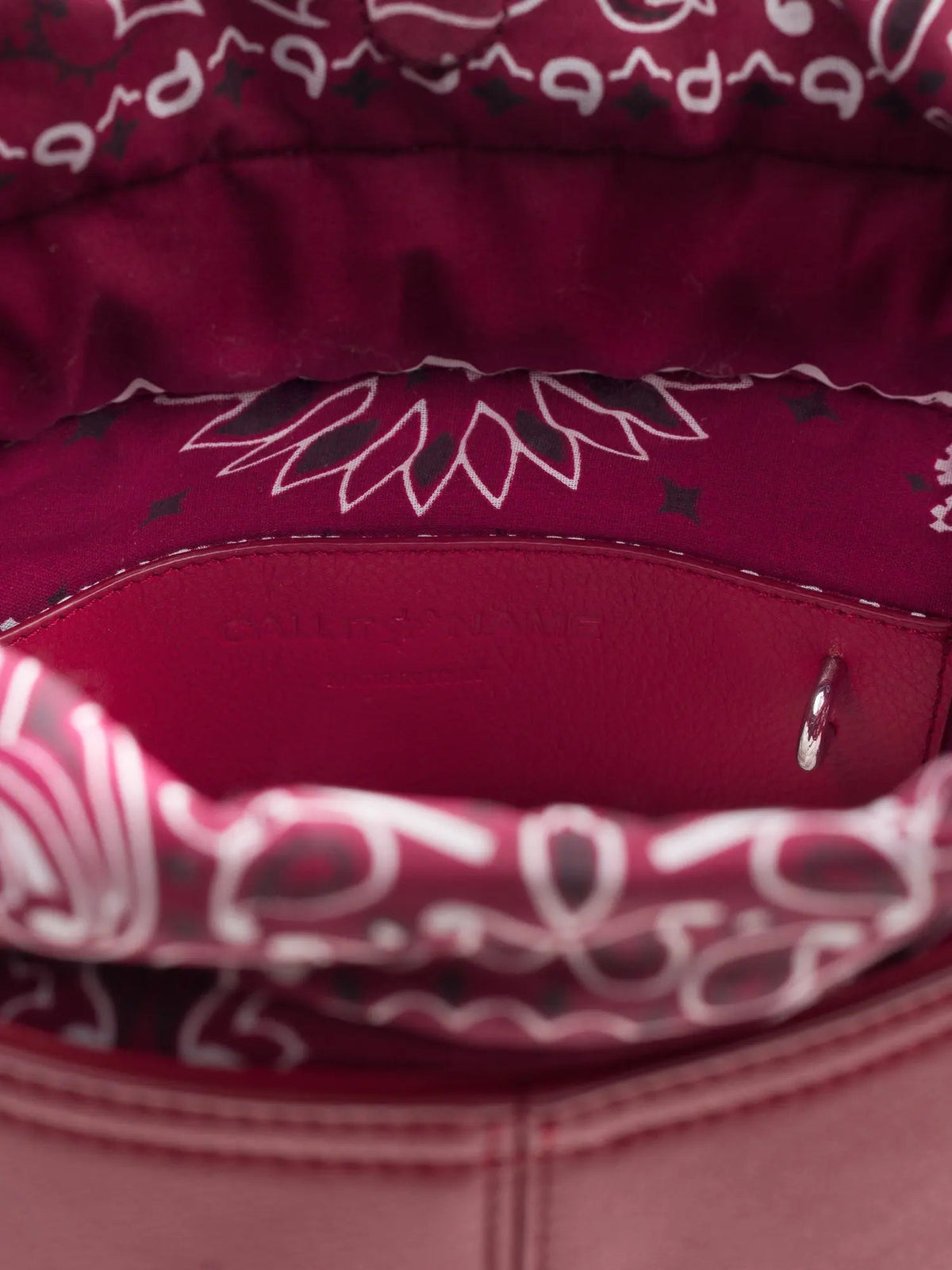 Inside of the Call It By Your Name cherry Peekaboo bag showing the red bandana-print lining