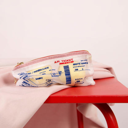 Brigitte Tanaka Air Ticket organza pouch on a red table
