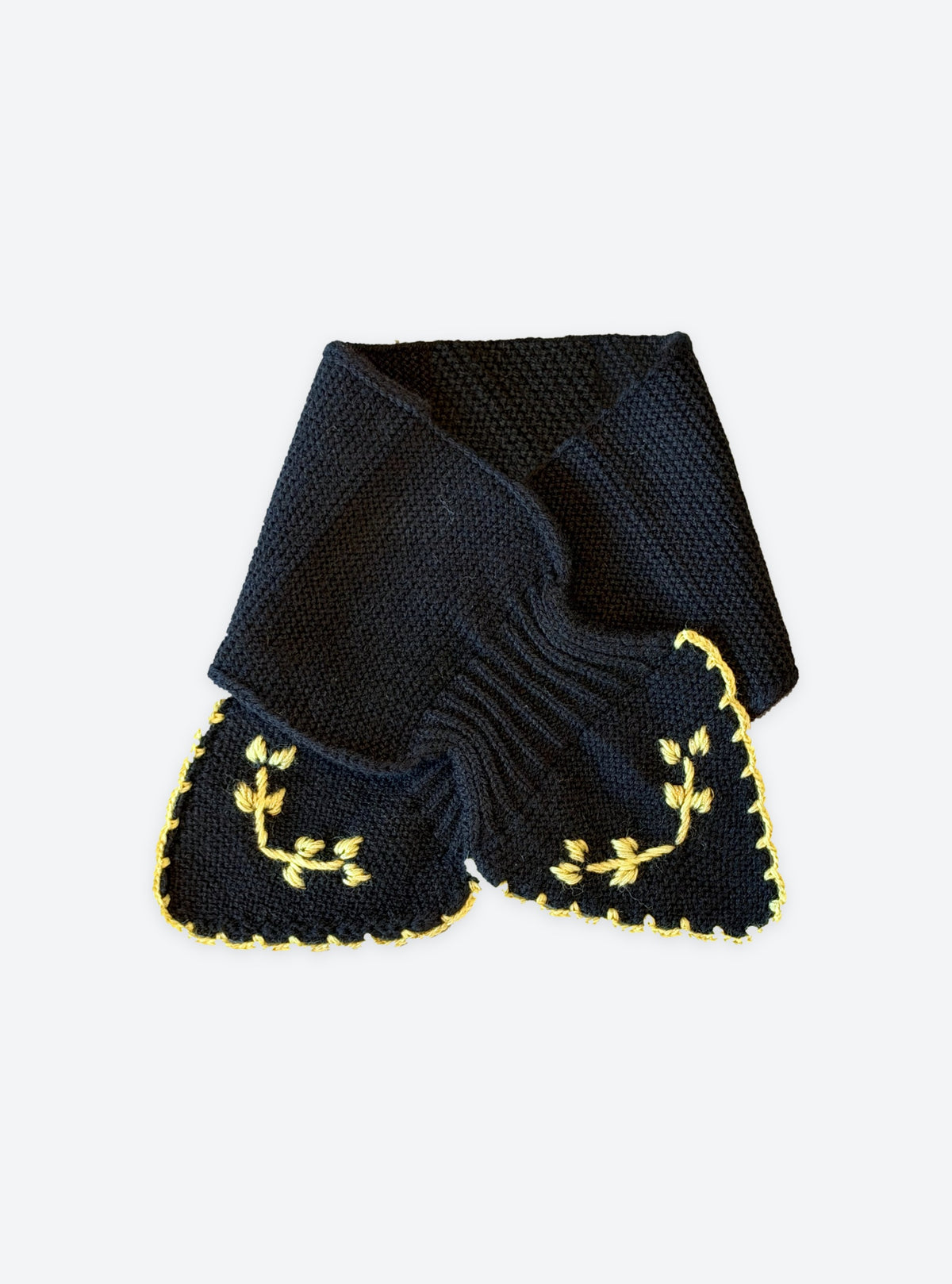 Flat-lay view of the Molli Dolce2 hand-embroidered neck scarf in deep black with gold leaf embroidery and scalloped blanket-stitch edging
