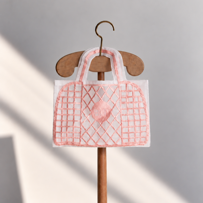 Brigitte Tanaka Plastic Pink trompe-l'oeil tote in pink organza, on a wooden hanger
