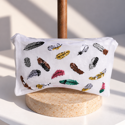 Brigitte Tanaka Feather pouch in white organza with multicolor feather embroidery, on a wooden stand