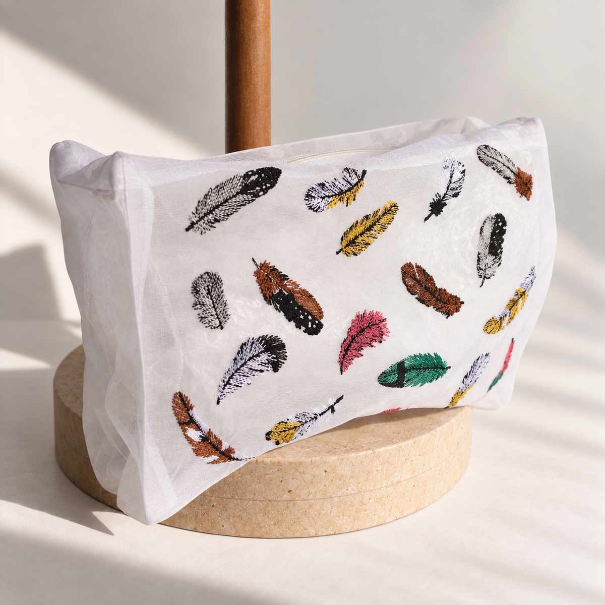 Side view of the Brigitte Tanaka Feather pouch with colorful embroidered feathers