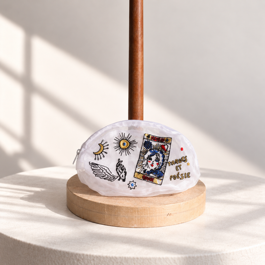 Brigitte Tanaka x Moulin Rouge oval tarot pouch in white organza, front view on a wooden stand
