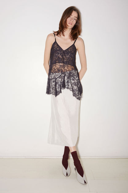 Roseanna Latte navy lace camisole styled with a white skirt, full-length view
