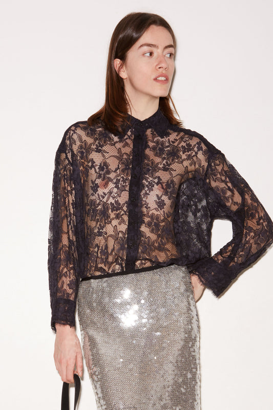 Front view of the Roseanna Tish navy Chantilly lace shirt worn with a silver sequin skirt